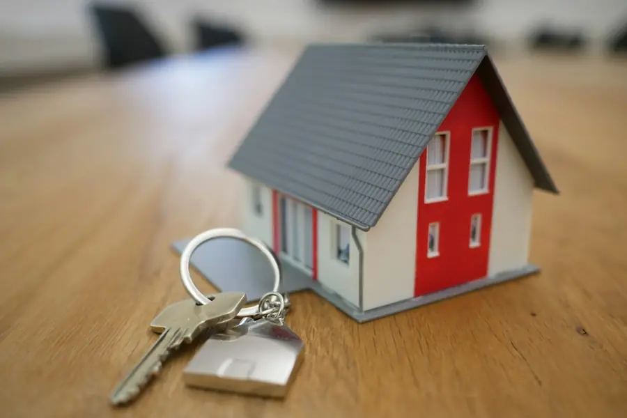 House keys and a model house on a desk